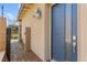Inviting front door with a secure lock and light fixture next to a well-kept yard at 767 Tallgrass St, Las Vegas, NV 89138