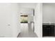 Bright hallway with sleek tile floors leads to the backyard; features a convenient side counter with storage space at 767 Tallgrass St, Las Vegas, NV 89138
