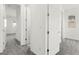 Bright hallway features neutral walls, gray carpet, and white doors at 767 Tallgrass St, Las Vegas, NV 89138