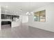 Bright open floor plan with modern kitchen featuring dark cabinets and a pendant light at 767 Tallgrass St, Las Vegas, NV 89138