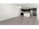Open concept floor plan with a view of the kitchen featuring dark cabinets and stainless appliances at 767 Tallgrass St, Las Vegas, NV 89138