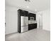 This kitchenette features dark cabinets, stainless steel appliances, and white countertops at 767 Tallgrass St, Las Vegas, NV 89138
