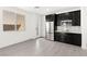 This kitchenette features dark cabinets, stainless steel appliances, and views of the yard at 767 Tallgrass St, Las Vegas, NV 89138