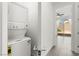 This laundry area features a stacked washer and dryer and tile flooring at 767 Tallgrass St, Las Vegas, NV 89138