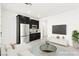 Cozy living space boasts a wet bar, stainless steel refrigerator, and sleek black cabinets at 767 Tallgrass St, Las Vegas, NV 89138