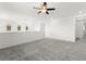 Neutral loft with plush carpet, ceiling fan, and view of the window at 767 Tallgrass St, Las Vegas, NV 89138