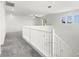 Light-filled loft featuring plush carpeting, railing, and a ceiling fan at 767 Tallgrass St, Las Vegas, NV 89138