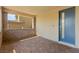 Covered front porch with stone accents and a modern blue front door provides a welcoming entry at 767 Tallgrass St, Las Vegas, NV 89138