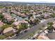 Aerial of residential area with mature landscaping, tile roofs and well-maintained streets at 7837 Fort Ruby Pl, Las Vegas, NV 89128