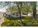 Beautiful backyard with artificial turf, mature trees, and covered patio space at 7837 Fort Ruby Pl, Las Vegas, NV 89128