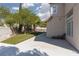 Large backyard featuring a concrete patio, artificial turf, and landscaping at 7837 Fort Ruby Pl, Las Vegas, NV 89128