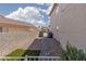 Side yard with stone landscaping, artificial turf, and private gated area at 7837 Fort Ruby Pl, Las Vegas, NV 89128