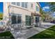 Home exterior from the backyard, featuring a patio, artificial grass, and mature landscaping at 7837 Fort Ruby Pl, Las Vegas, NV 89128