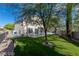 Expansive backyard with artificial grass, mature trees, and gravel side yard at 7837 Fort Ruby Pl, Las Vegas, NV 89128