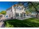 A large backyard with artificial grass, a paved patio, and mature landscaping at 7837 Fort Ruby Pl, Las Vegas, NV 89128