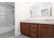 Bathroom with granite countertops, dual sinks, and a glass-enclosed shower-tub combo offering both style and functionality at 7837 Fort Ruby Pl, Las Vegas, NV 89128