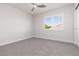 Bright bedroom featuring plush carpeting, a modern ceiling fan, and natural light from a window at 7837 Fort Ruby Pl, Las Vegas, NV 89128