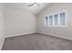 The empty bedroom boasts a ceiling fan and white plantation shutters allowing natural light to gently illuminate the space at 7837 Fort Ruby Pl, Las Vegas, NV 89128