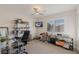 Bright bedroom featuring modern decor, a ceiling fan, and large windows for natural light at 7837 Fort Ruby Pl, Las Vegas, NV 89128