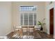 Bright dining room featuring hardwood floors, plantation shutters, and natural light at 7837 Fort Ruby Pl, Las Vegas, NV 89128