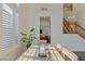 Bright dining room with large windows and a view of the staircase at 7837 Fort Ruby Pl, Las Vegas, NV 89128