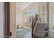View of the living room and staircase from the front door with ample natural light and hardwood floors at 7837 Fort Ruby Pl, Las Vegas, NV 89128