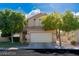 Inviting two-story home featuring a well-manicured lawn and mature trees providing shade and curb appeal at 7837 Fort Ruby Pl, Las Vegas, NV 89128