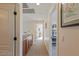 Hallway with a built-in wood cabinet and neutral carpet offering a transition space between rooms at 7837 Fort Ruby Pl, Las Vegas, NV 89128