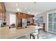 Bright kitchen with stainless steel appliances, large windows, and an adjacent dining area at 7837 Fort Ruby Pl, Las Vegas, NV 89128