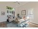 Cozy living room with vaulted ceilings and natural light from large windows at 7837 Fort Ruby Pl, Las Vegas, NV 89128
