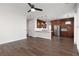Open concept living room with dark wood floors, recessed lighting, and view of the modern kitchen at 7837 Fort Ruby Pl, Las Vegas, NV 89128