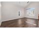 Bright, spacious living room featuring sleek hardwood floors and large windows with plantation shutters at 7837 Fort Ruby Pl, Las Vegas, NV 89128