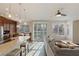 Spacious living room connected to the kitchen, featuring hardwood floors and ample natural light at 7837 Fort Ruby Pl, Las Vegas, NV 89128