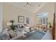Open-concept living room featuring vaulted ceilings, hardwood floors, and a comfortable seating area with a ceiling fan at 7837 Fort Ruby Pl, Las Vegas, NV 89128
