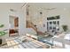 Open-concept living room with a staircase, dining area, and plenty of natural light at 7837 Fort Ruby Pl, Las Vegas, NV 89128