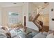 Bright living room with a staircase, dining area, and plenty of natural light at 7837 Fort Ruby Pl, Las Vegas, NV 89128