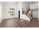 Bright living room boasts wood-look floors, high ceilings, and a staircase to the second floor at 7837 Fort Ruby Pl, Las Vegas, NV 89128