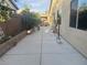Backyard features a long concrete patio and partial landscaping offering an outdoor living space at 7934 Cape Flattery Ave, Las Vegas, NV 89147