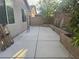 Concrete backyard patio area with block wall fencing and landscaping at 7934 Cape Flattery Ave, Las Vegas, NV 89147