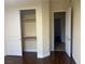 Bedroom with sliding closet doors and hardwood flooring, offering functional storage at 7934 Cape Flattery Ave, Las Vegas, NV 89147