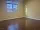 Bright bedroom with hardwood floors and a large window offering natural light at 7934 Cape Flattery Ave, Las Vegas, NV 89147