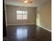 Bedroom featuring wood floors, neutral wall color, and large window at 7934 Cape Flattery Ave, Las Vegas, NV 89147