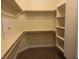 Walk-in closet features carpet flooring and built-in shelving for organized storage at 7934 Cape Flattery Ave, Las Vegas, NV 89147