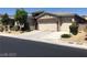 Contemporary home featuring a three-car garage and desert landscaping at 7934 Cape Flattery Ave, Las Vegas, NV 89147