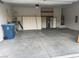 Spacious two-car garage with ample storage solutions, a utility closet, and an included refrigerator at 7934 Cape Flattery Ave, Las Vegas, NV 89147
