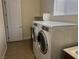 Laundry room with front load washer and dryer and tiled floor at 7934 Cape Flattery Ave, Las Vegas, NV 89147
