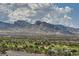 This aerial view captures mountains, a golf course, and a residential area at 9101 Alta Dr # 1203, Las Vegas, NV 89145
