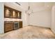 Stylish bar area with custom cabinetry, beverage refrigerator, and elegant lighting, perfect for entertaining and relaxation at 9101 Alta Dr # 1203, Las Vegas, NV 89145