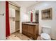 This bathroom has a marble countertop, matching framed mirror and tiled floors at 9101 Alta Dr # 1203, Las Vegas, NV 89145