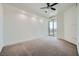 This bedroom has neutral carpet, recessed lighting, a ceiling fan and a large patio door at 9101 Alta Dr # 1203, Las Vegas, NV 89145